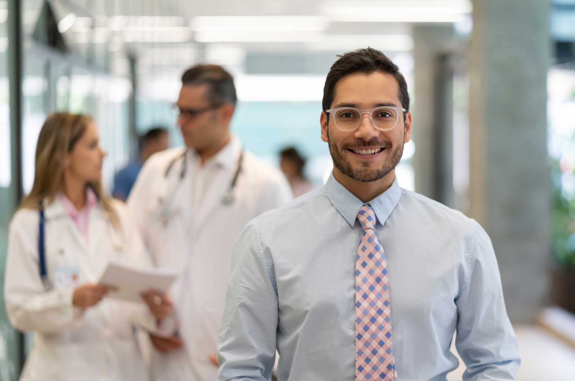 man with glasses smiling for camera
